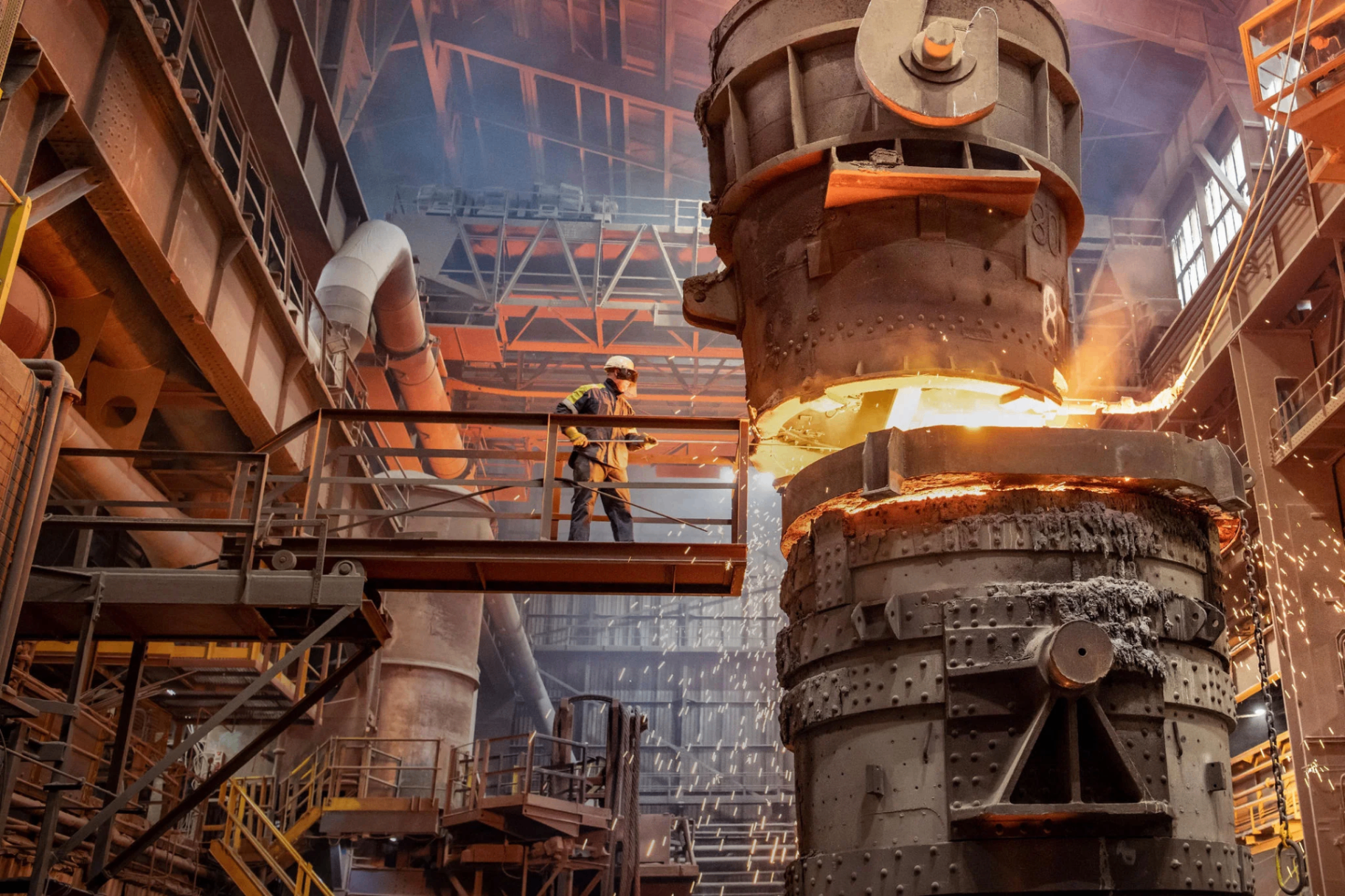 Steel mill worker on platform near furnace